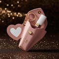 Floranthia Essentials Lip Oil Heart Keychain Case — pink PU leather heart case with gold hardware on dark glamorous background